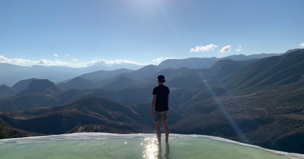 queer person standing alone at a petrified waterfall in mexico