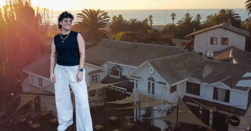 Queer woman superimposed over a sunset shot of her hostel in Chile