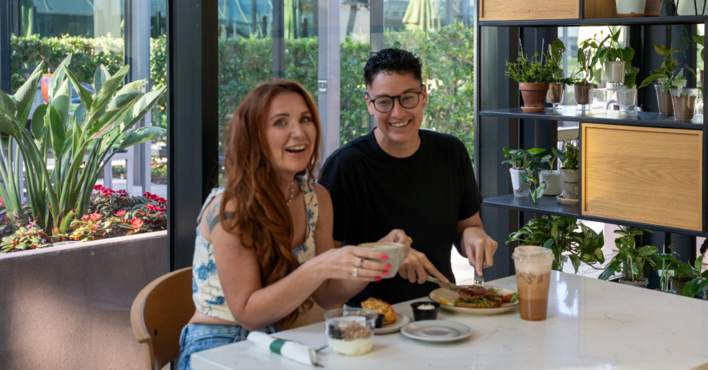 queer people sitting together in a restaurant in Costa Mesa, sharing brunch