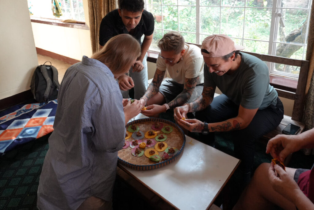 group of queer people learning to fold momos 