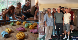 a group of queer travelers with a Pride flag and Trans flag at Everest Base Camp in Nepal
