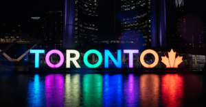 a sign reading 'TORONTO' with bright, colorful lights